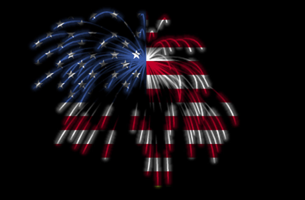 Fireworks bursting in the pattern of an American flag against a night sky