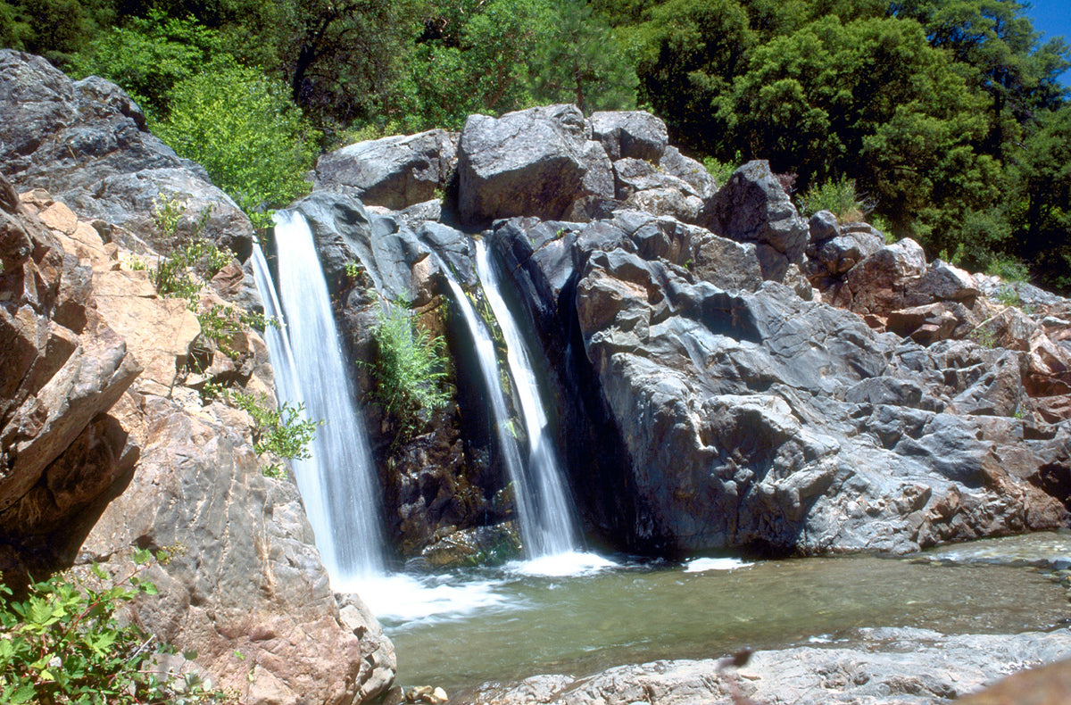 A small waterfall tumbles over granite boulders into a swimming hole on the South Yuba River near Nevada City